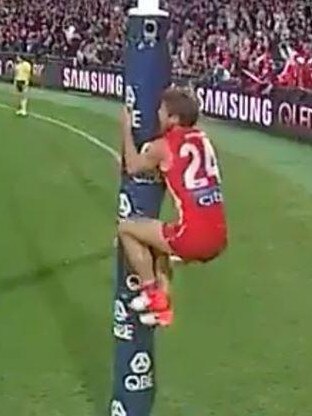 Dane Rampe climbs the goalpost as David Myers takes his shot after the siren.