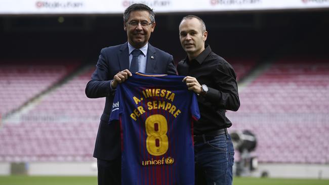 FC Barcelona's Andres Iniesta (R) and FC Barcelona's president Josep Maria Bartomeu.