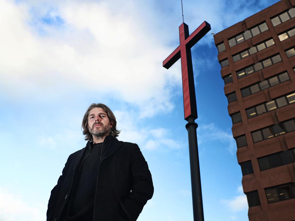 Dark Mofo Creative Director in front of the first cross being put up on Hobart's waterfront. Picture: LUKE BOWDEN