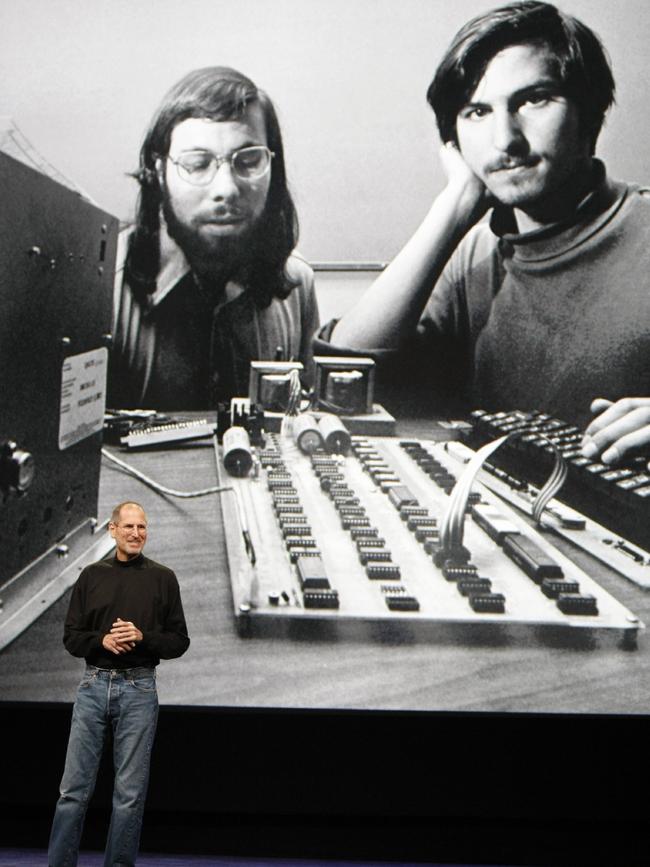 Then Apple CEO Steve Jobs stands in front of a photo of himself, right, and Steve Wozniak, left, during an event in San Francisco. College dropouts Jobs and Wozniak founded Apple in 1976. Picture: AP