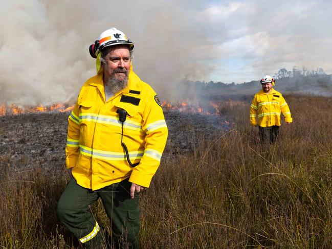 Tasmanian Parks and Wildlife Service program to re-introduce Aboriginal burning practices in the Tasmanian environment.Colin Hughes, one of the first Tasmanian Aboriginal Fire Rangers and currently working for Aboriginal Heritage Tasmania with Josh Mansell, working on a burn at Dempster Plains in the North West of Tasmania.26/08/2021photo - Peter Mathew