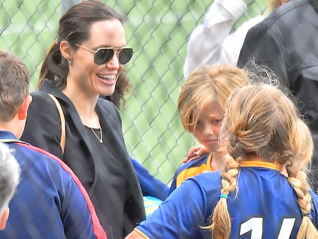 Chatting with Shiloh’s teammates. Angelina and daughter Shiloh (middle). Credit: Splash News Australia.