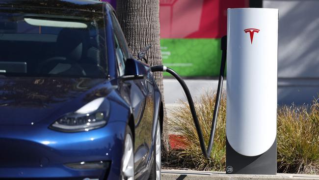 A Tesla car sits at a Tesla Supercharger station. Picture: Justin Sullivan/Getty Images/AFP