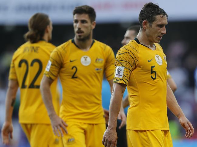 Australia's midfielder Mark Milligan, right, leaves the pitch with teammates at the end of the AFC Asian Cup group B soccer match between Australia and Jordan at Hazza bin Zayed stadium in Al Ain, United Arab Emirates, Sunday, Jan. 6, 2019. Jordan won 1-0. (AP Photo/Hassan Ammar)