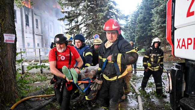 Rescuers carry a wounded person out of the ruins following Russian attacks. Picture: AFP