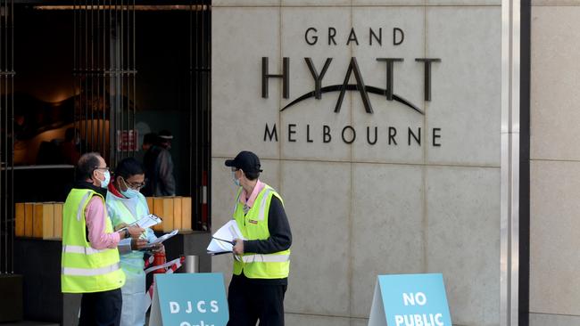 Health and logistics staff outside the Grand Hyatt on Collins Street, one of three quarantine hotels for tennis players competing in the upcoming Australian Open. Picture: NCA NewsWire / Andrew Henshaw