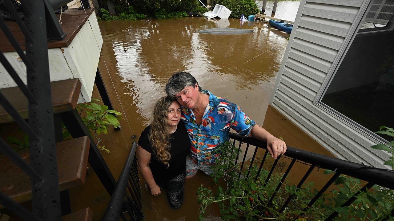 Michael and Katrina Bender with floodwaters on their property in Caboolture. Picture: Lyndon Mechielsen