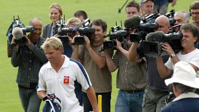 Warne followed by photographers at Junction Oval in Melbourne after being suspended.