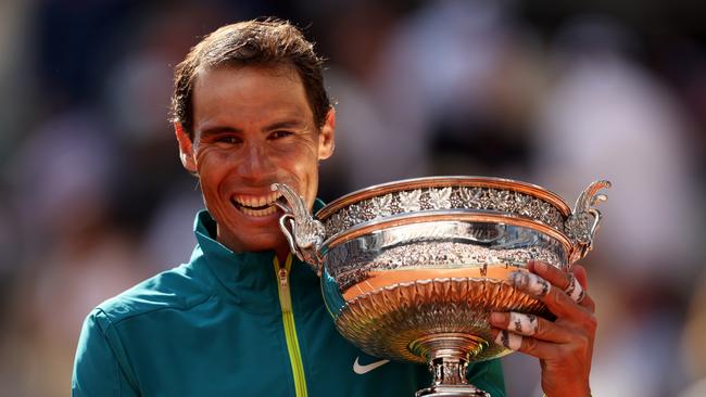 Rafael Nadal bites the trophy after winning a 14th French Open title. Picture: Getty