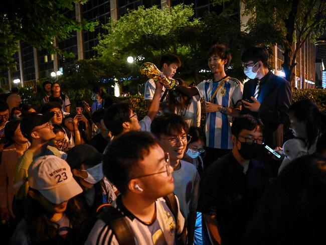 Chinese fans react after they catch a glimpse of the Argentine national football team outside a hotel where the team is staying in Beijing on June 12, 2023. Argentina will play a friendly football match against Australia on June 15 at Beijing's newly-renovated 68,000-capacity Workers' Stadium. (Photo by JADE GAO / AFP)