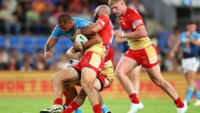 GOLD COAST, AUSTRALIA - MARCH 30: Phillip Sami of the Titans is tackled during the round four NRL match between Gold Coast Titans and Dolphins at Cbus Super Stadium, on March 30, 2024, in Gold Coast, Australia. (Photo by Chris Hyde/Getty Images)