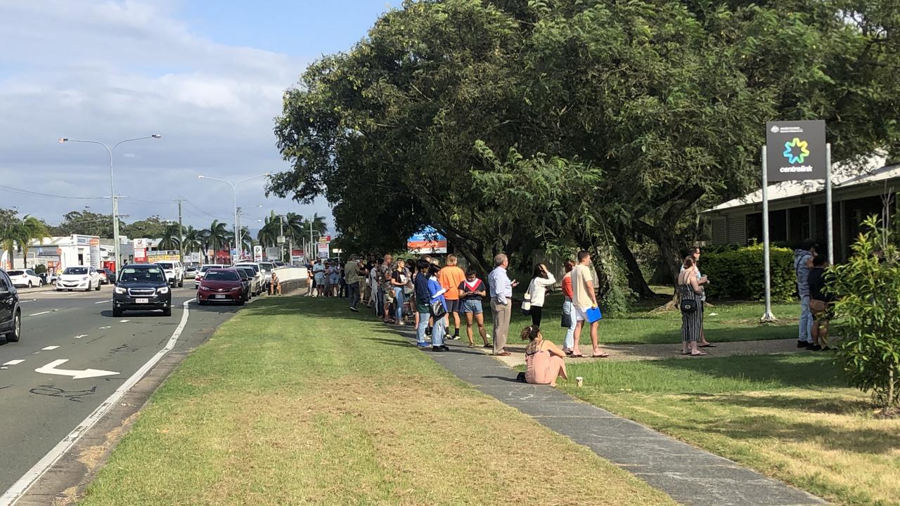 The line outside the Biggera Waters Centelink stretching down Brisbane Road.