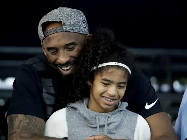 Former Los Angeles Laker Kobe Bryant and his daughter Gianna watch during the U.S. national championships swimming meet. Picture: AP