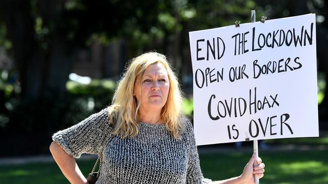 A woman holds a sign during a Freedom Day protest in Hyde Park, Sydney. Picture: NCA NewsWire/Joel Carrett