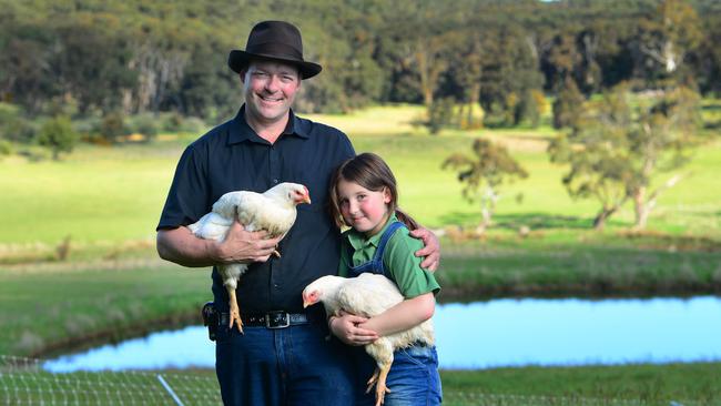 On-farm ambition: Ben Falloon and his daughter Maya, 9, at Taranaki Farm, where he hopes to set up his own micro-abattoir to process chickens. Picture: Zoe Phillips