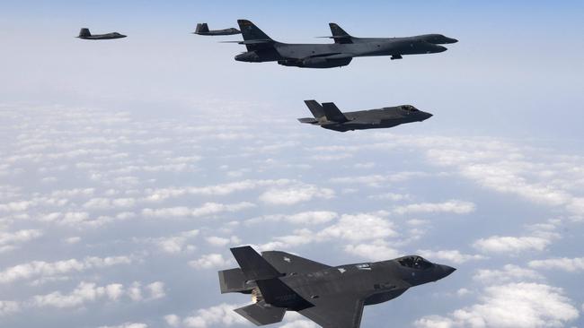 This handout photo taken on February 1, 2023 Air Force B-1B strategic bombers, South Korean Air Force F-35 fighter jets and US Air Force F-22 stealth fighter jets flying over the Yellow Sea, located between China and the Korean peninsula, during a joint air drill. Picture: AFP