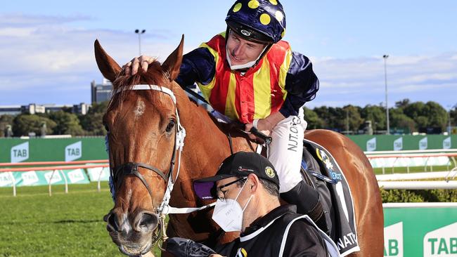 James McDonald gives nature Strip a pat after their win in The Everest at Randwick. Picture: Getty Images