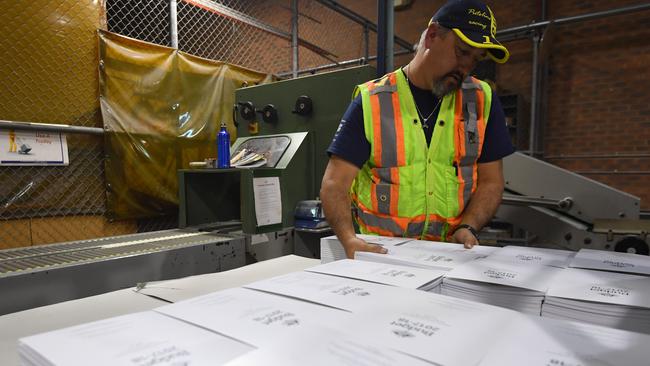 A man prepares a stack of the 2017-18 Budget papers in Canberra. Picture: AAP