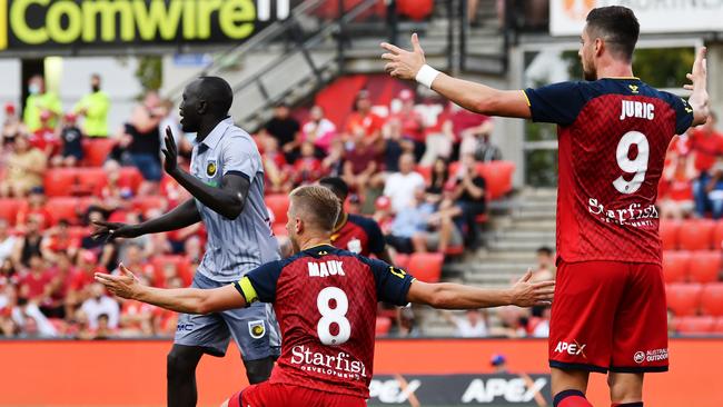 Adelaide United Stefan Mauk and Tomi Juric successfully appeal for a penalty after a foul by Central Coast’s Ruon Tongyik at Coopers Stadium. Picture: Getty Images