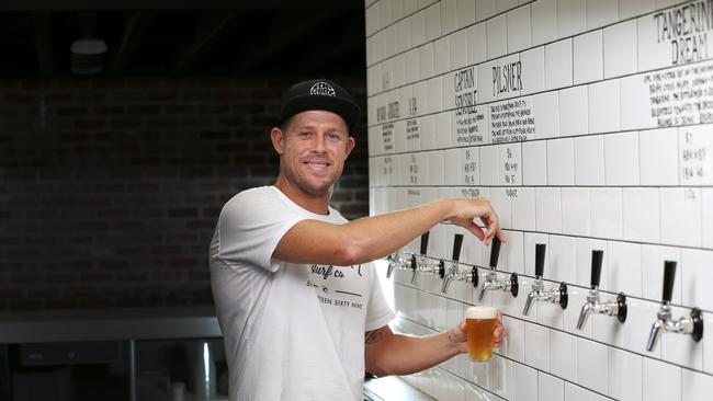 Mick Fanning celebrates with a beer at his Balter brewery at Currumbin. Picture: NIGEL HALLETT