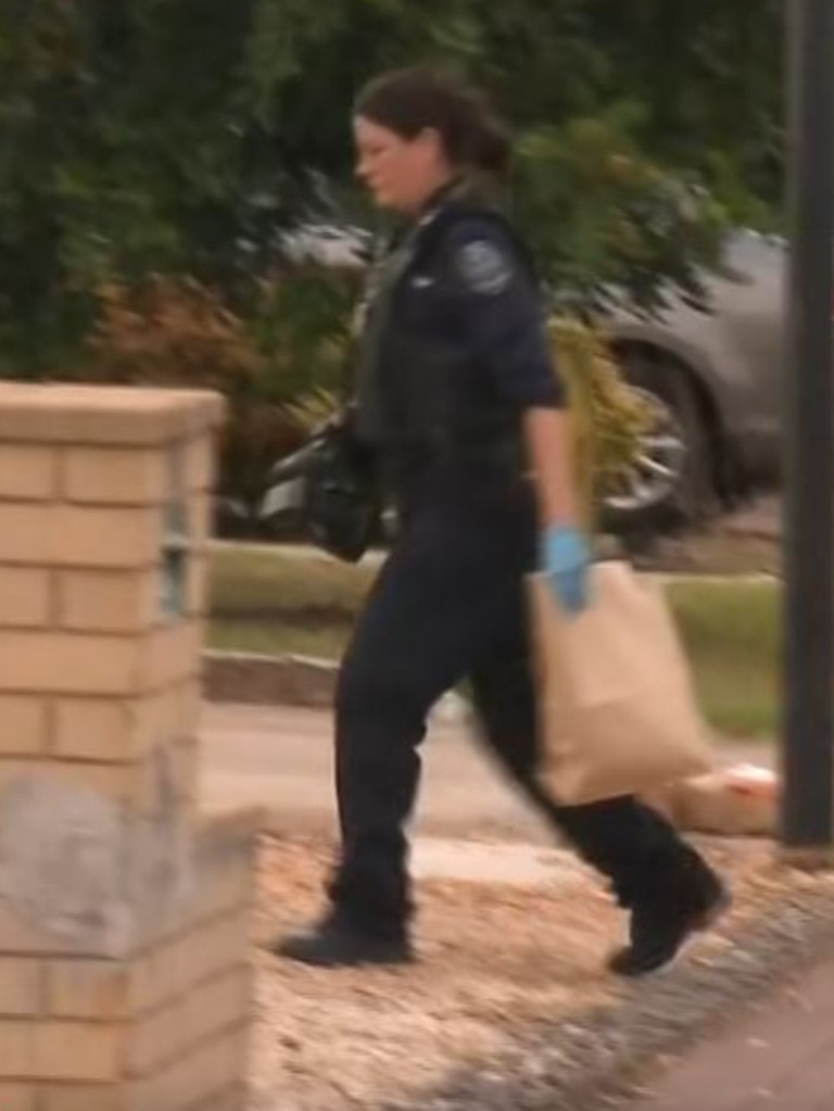 An officer takes evidence from the scene. Picture: 7NEWS