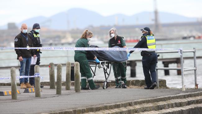 Coroners remove a body from the scene of a drowning in Geelong. Picture: Alan Barber