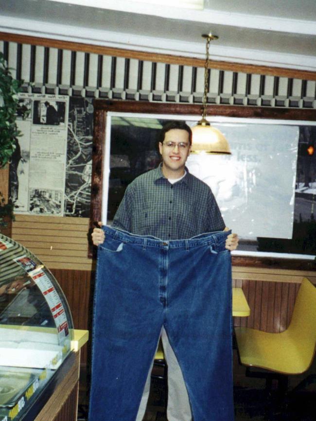 Fogle holds a pair of jeans he used to wear before losing weight.