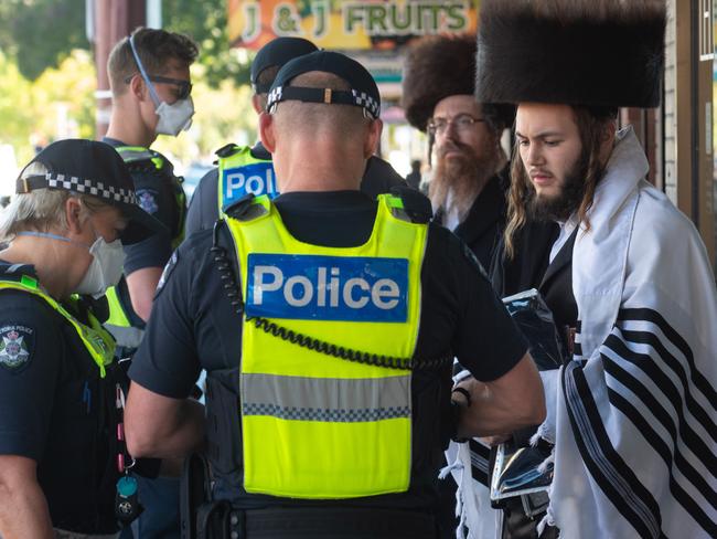 Police fine members of a Jewish Synagogue that have broken the Social distancing rule in Glen Eira road, Ripponlea. Picture: Tony Gough