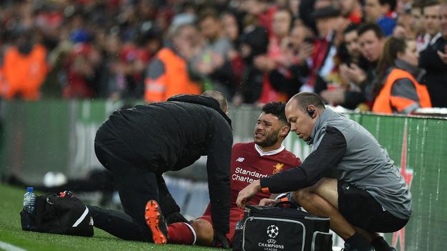 Liverpool's English midfielder Alex Oxlade-Chamberlain (C) picks up an injury