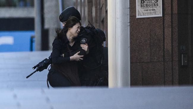 A hostage escapes the Lindt cafe during the Sydney siege. Picture: Chris McKeen