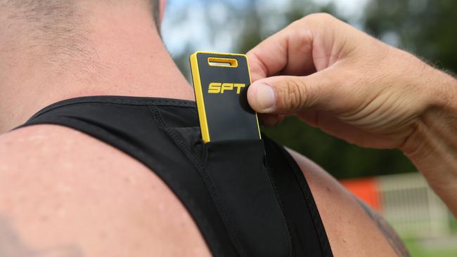 Darrin Borthwick inserts Sports Performance Tracker into player’s vest to collect data. Photo: Ian Svegovic