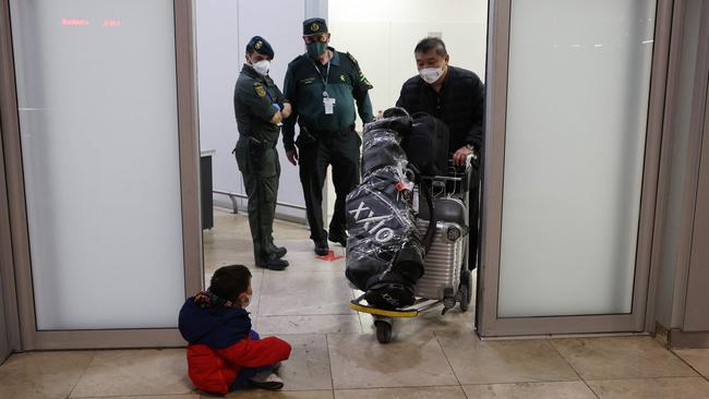 Passengers of a flight from Beijing leave the terminal after landing at the Adolfo Suarez Madrid-Barajas airport in Barajas, on the outskirts of Madrid.