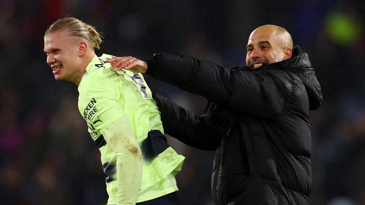 Erling Haaland and Pep Guardiola, Manager of Manchester City, celebrate after the team's victory over Crystal Palace.