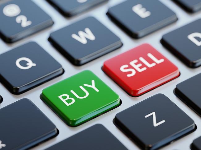 Modern computer keyboard with buy and sell buttons and copy space. Horizontal composition with selective focus. Great use for investment, forex and savings related concepts.