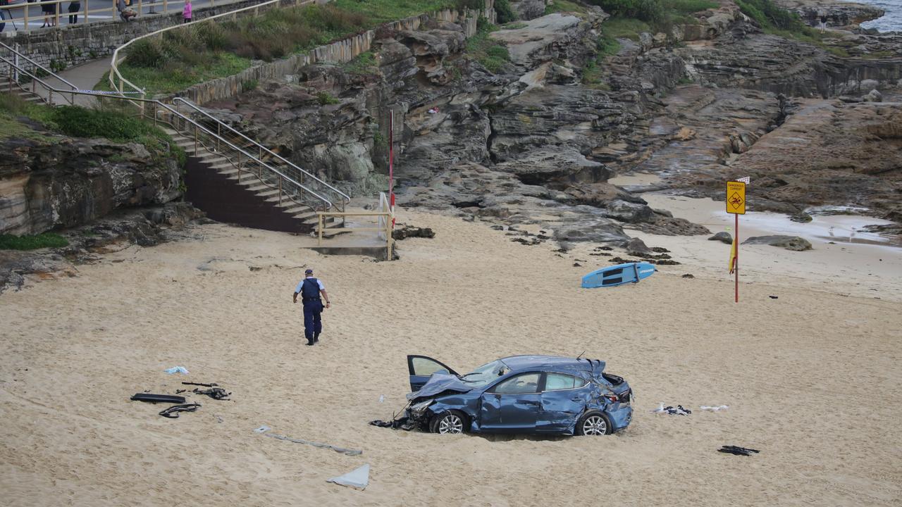 The car landed on the sand at Maroubra Beach after it crashed through a barrier on Marine Parade and ended up on the sand. Picture: Christian Gilles