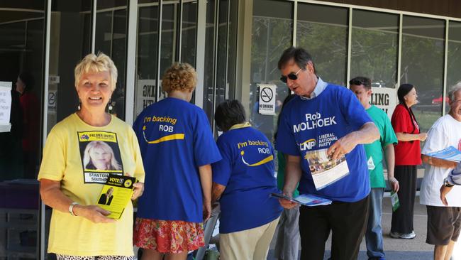 Party volunteers hand out voting material to people casting their vote early at the Southport Community Centre. Pic Tim Marsden