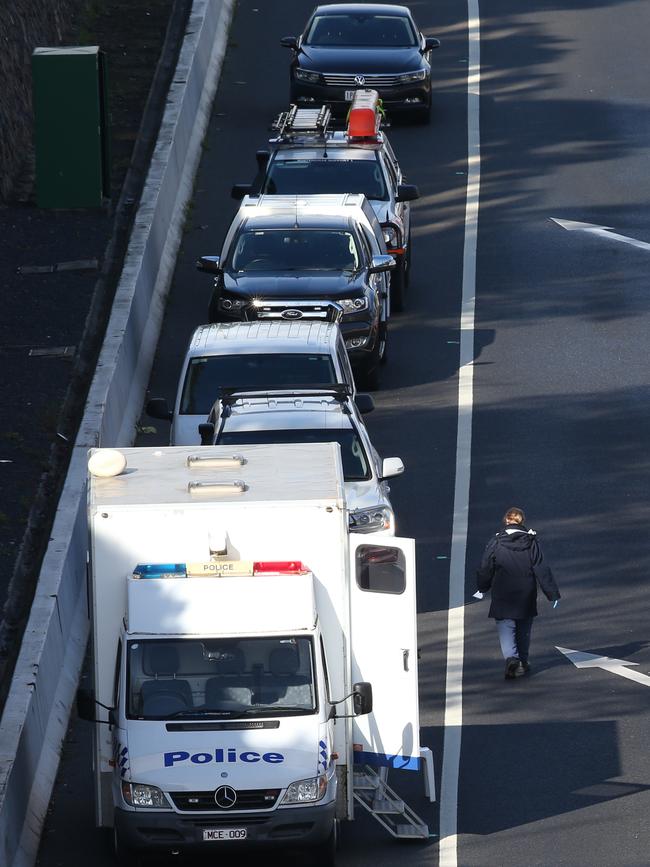 Police and emergency services on the Eastern Freeway after the shooting.