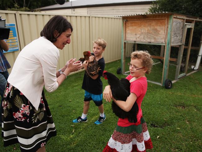 The Premier plays with Mason, 9, and Angel, 7, who’ve been adopted by the James family of Toongabbie. Picture: Phil Hillyard