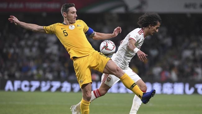 Mark Milligan vies for the ball with United Arab Emirates midfielder Mohammed Abdulrah in the Asian Cup quarter-final. Picture: AP