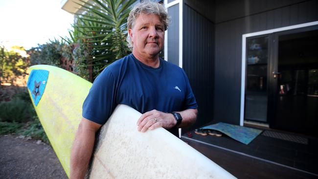 Surfer Peter Lobb with his board they used to carry Chantelle to the ambulance. Picture: Nathan Edwards