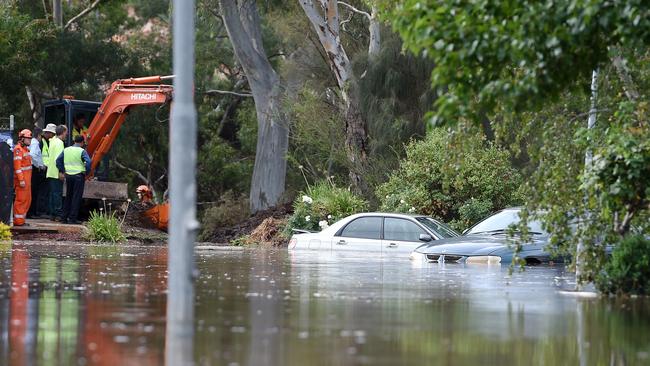 Cars half underwater after the water main burst, flooding homes around Willow Dr in Paradise. Picture Roger Wyman