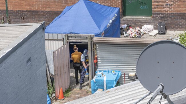 Police at the rear of the boarding house. Picture: Monique Harmer