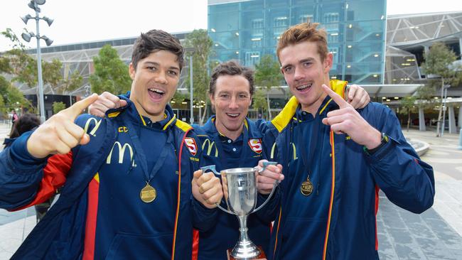 SA coach Tony Bamford with players Tom Lewis and Jez McLennan at Adelaide Airport after winning last year’s national under-18 championships. Picture: AAP/Brenton Edwards