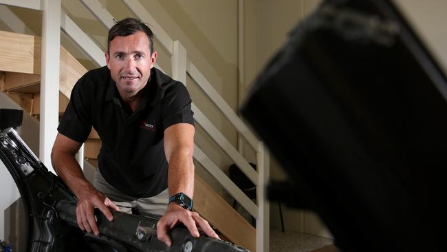 Nick Ray of Onesector Construction checks a stripped BMW car inside a unit at his Arundel project called Prestige Strata Units. His new project in Molendinar is called Mancave Strata Units. Photo: Regi Varghese