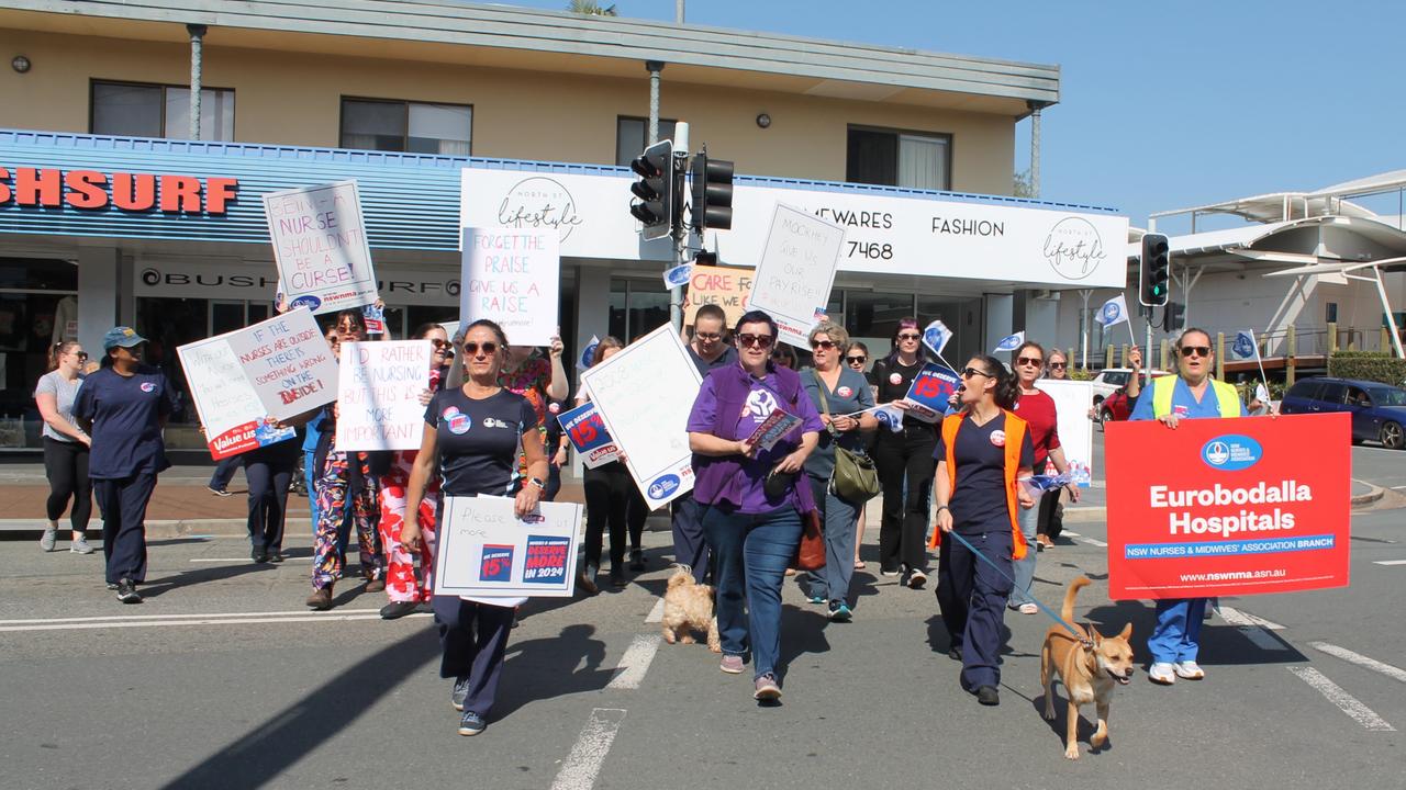 The striking nurses marched the Batemans Bay CBD displaying their signs. Picture: Tom McGann.