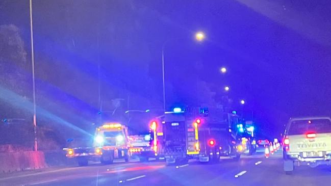 Emergency services at the scene of an accident on the M1 at Pimpama in which a motorist was trapped inside their vehicle.