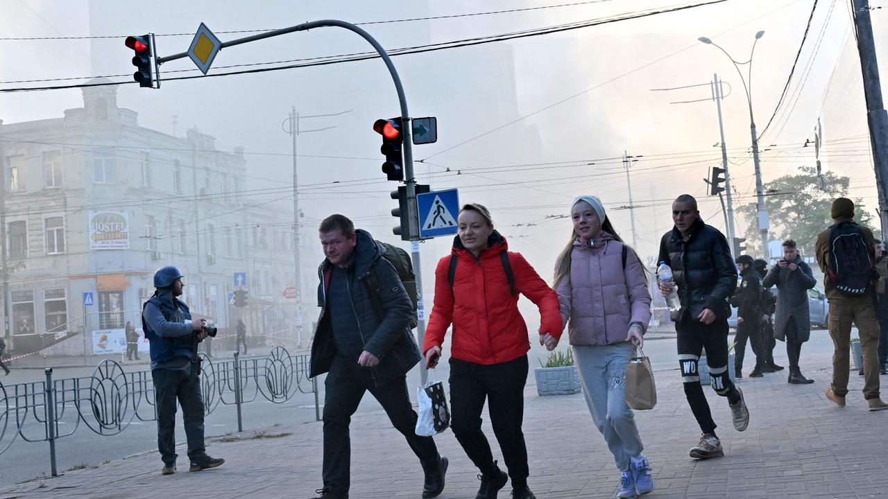 Residents run away after a drone attack in Kyiv on October 17. Picture: Sergei Supinsky/AFP