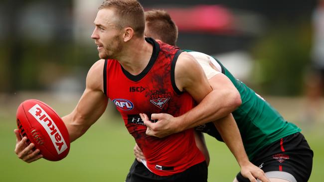 Devon Smith is tackled by Martin Gleeson at Essendon training.