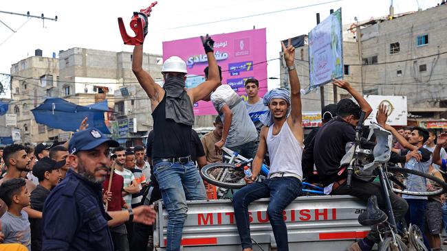 Palestinians celebrate their return after crossing the border fence with Israel from Khan Yunis, in the southern Gaza Strip, on October 7, 2023. Picture: Said Khatib/AFP