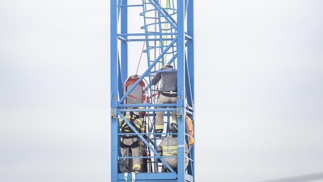 Emergency services rescue a crane driver who fell down a crane shaft in Alphington. Picture: Jake Nowakowski